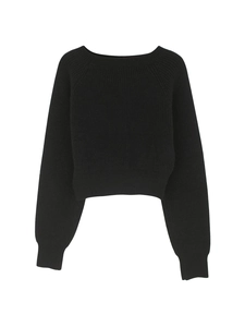 Detail of ribbed cuffs and hem on a cropped black crewneck knitted sweater