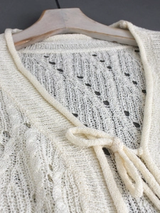 Chic pointelle knit cardigan with deep V-neck and ribbon tie closure in cream white