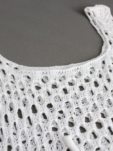 White crochet knit tank top featuring hollow-out patterns and round neck for summer beach