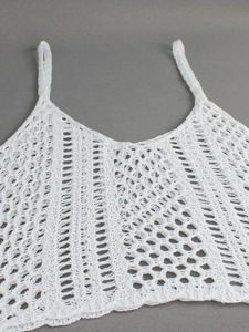 White crochet knit camisole top with intricate hollow patterns and delicate thin straps
