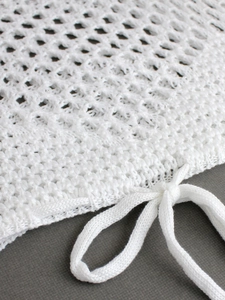 White knit crochet crop top with hollow mesh texture and drawstring tie detail
