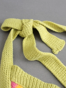 Women's V-neck sleeveless knit vest featuring vibrant green crochet with colorful patterns