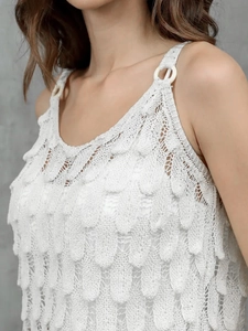 White sleeveless hollowed-out knit top with feather-like texture and buckle detail