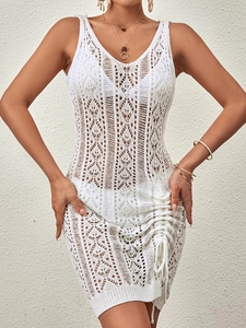 White sleeveless crochet knit beach dress with hollow patterns and side drawstring details