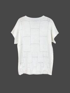 Detail of white short sleeve knit top featuring a checkered openwork crochet pattern