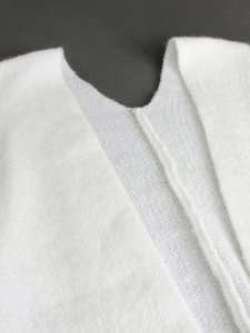 V-neck detail of white mohair cardigan with fluffy wool texture and knit finish