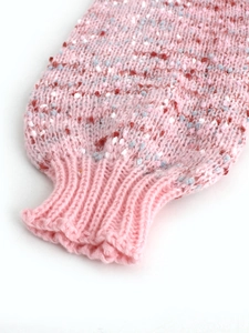 Pink speckled knit cardigan sleeve with colorful flecks and wide ribbed cuffs detail