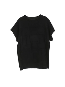 Detail of black knitted round neck top featuring textured checkerboard hollow-out pattern