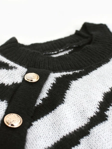 Women's crewneck zebra print sweater with ornate gold buttons and knit texture