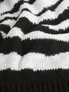 Detailed close-up of soft black and white zebra pattern knit sweater with fuzzy texture