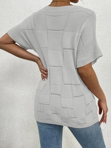 Detail of grey short sleeve knit top showing hollow out checkerboard texture on the back