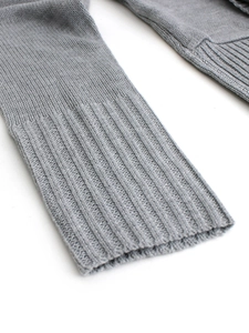 Detailed macro view of the ribbed knit cuffs and fine texture on a grey cardigan jacket