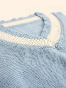 Détail du débardeur en maille bleu clair à col en V avec rayures blanches contrastées