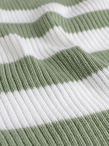 Close-up of rib-knit texture on sage green and white striped V-neck sweater dress
