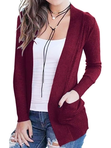 Detail view of burgundy knit cardigan featuring ribbed cuffs and side pockets on a long fit