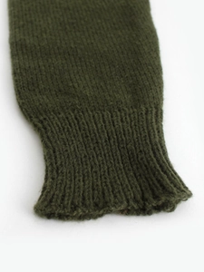 Women's dark green crewneck knit sweater featuring elastic ribbed cuffs and thick texture