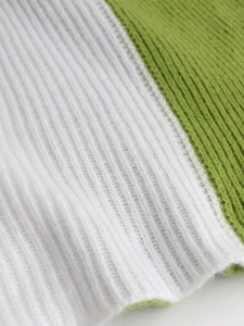 Close-up detail of soft ribbed knit fabric featuring white and grass green stripes