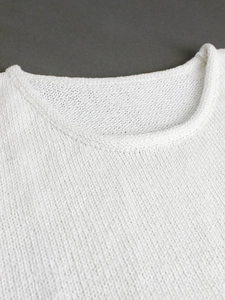 Women's white crewneck knitted sweater vest with minimalist textured knit design