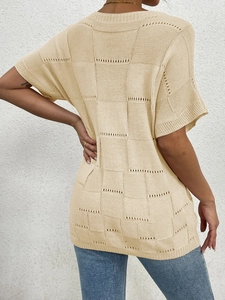 Detail of light beige checkered knit texture with breathable hollow-out design on back