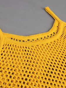 Close-up of yellow knit crochet tank top neckline and delicate shoulder straps detail