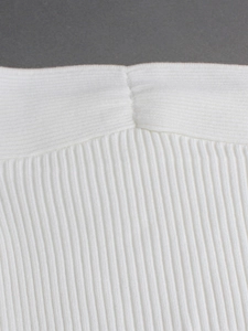 White ribbed knit crop top featuring detailed pleats and stitching for summer beach wear