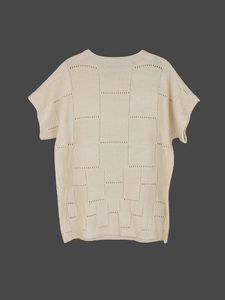 Detailed macro view of the cream knitted vest with geometric hollow-out pattern design