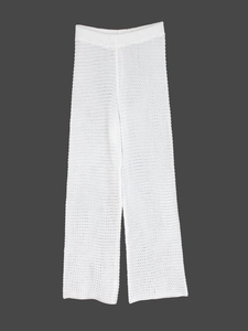 Close-up of white crochet knit wide-leg pants with hollow texture and wavy hem