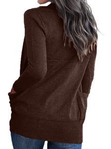 Detail view showing the ribbed hem and side pocket of the brown long-sleeved knit cardigan