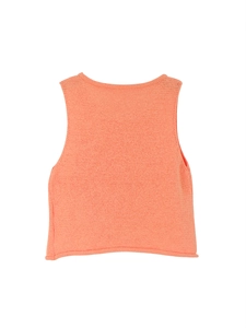 Close-up of bright orange knitted sleeveless vest showing detailed texture and rolled hem