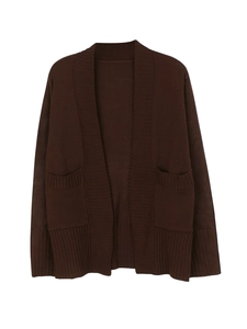 Detail of dark brown knitted cardigan featuring large front pockets and ribbed texture
