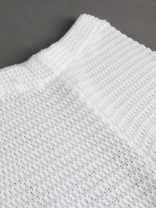 White knit beach pants featuring hollow-out crochet texture and elastic waistband detail