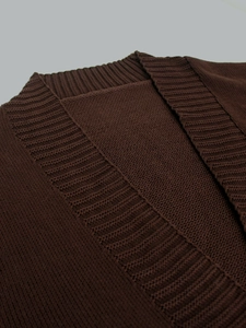 Close-up detail of dark brown ribbed neckline and fine knit texture on the cardigan