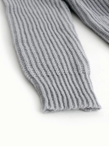 Detailed macro view of light grey knit sweater ribbed cuff with soft texture