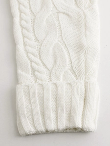 Detail of cable-knit texture and ribbed cuffs on this white long cardigan sweater