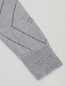 Women's grey knit sweater with hollow-out pattern and ribbed cuffs for autumn wear