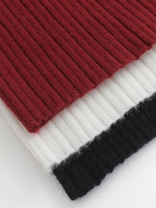 Texture macro del tessuto a maglia a coste in rosso, bianco e nero per maglioni invernali