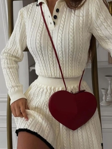 White cable knit long sleeve polo top and mini skirt set with a red heart-shaped bag