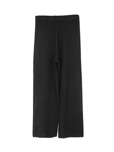 Detailed view of black crochet knit texture on wide-leg beach pants with mesh pattern