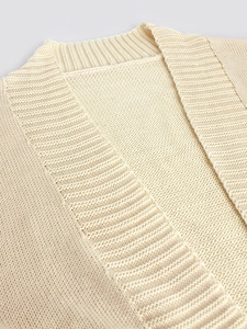 Close-up of the ribbed neckline and soft knit texture on this cream cardigan sweater