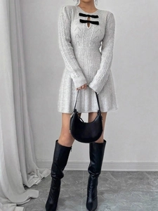 Grey cable knit mini dress with cutout neckline and black bows for autumn winter style