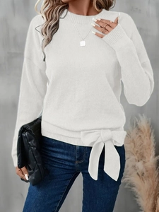 Detail of white knit sweater featuring vertical ribbing and side bow-knot ribbon decor