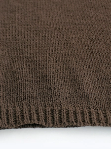 Deep brown minimalist knitted sweater vest with ribbed hem details and soft texture