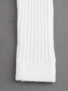 Elegant white ribbed knit off-shoulder sweater with soft texture and long sleeves