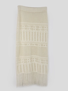 Chic cream knit midi skirt featuring hollow-out crochet patterns and tassel hem