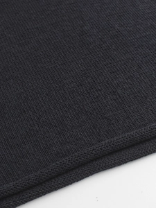 Close-up of the premium black knit texture and fine stitching on the sleeveless sweater