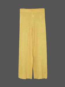 Detailed view of yellow crochet knit wide-leg pants with bohemian hollow-out patterns
