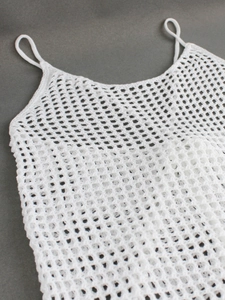 Elegant white knitted hollow-out maxi dress with crochet mesh texture for beach vacations