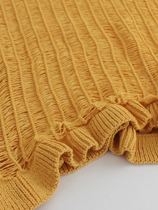 Knitted mustard yellow maxi dress with smocked texture and elegant ruffle hem detail
