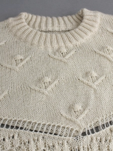 Chic cream-colored knitted crewneck sweater with diamond hollow-out patterns