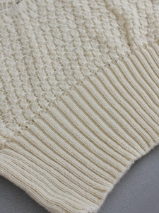 Women's knit long sleeve hollowed pullover featuring detailed wave patterns and ribbed hem